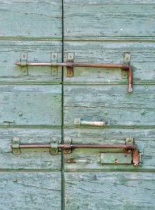 two old style latch locks on a blue door