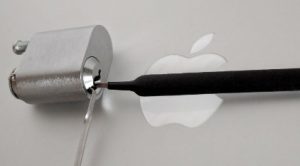 two lock pick tools opening a lock with apple logo in background